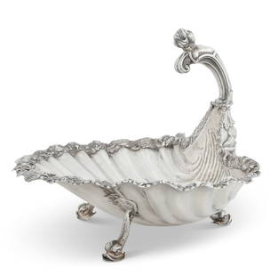 A Regency sterling silver shell form marine centerpiece basket, Robert Garrard, London, 1812: A Regency sterling silver shell form marine centerpiece basketRobert Garrard, London1812After a model by Paul de Lamerie, the handle engraved with heraldic crests and initial M surmounted by a coronet