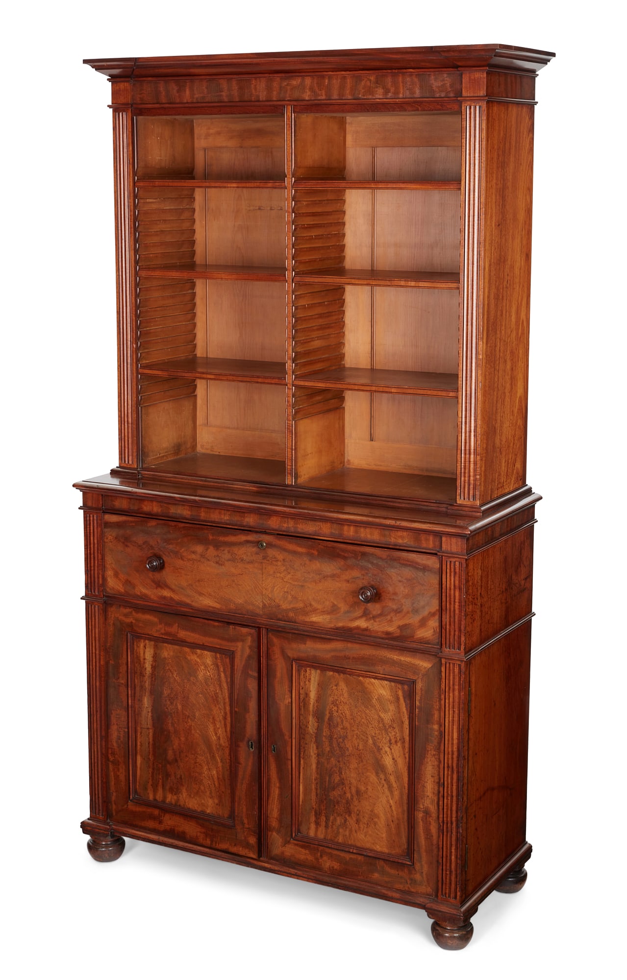 A George IV mahogany secretaire bookcase, Gillows, Lancaster, second quarter 19th century: A George IV mahogany secretaire bookcase Gillows, Lancaster second quarter 19th century The upper open section with six adjustable shelves above an outset base with secretaire drawer with hinged front