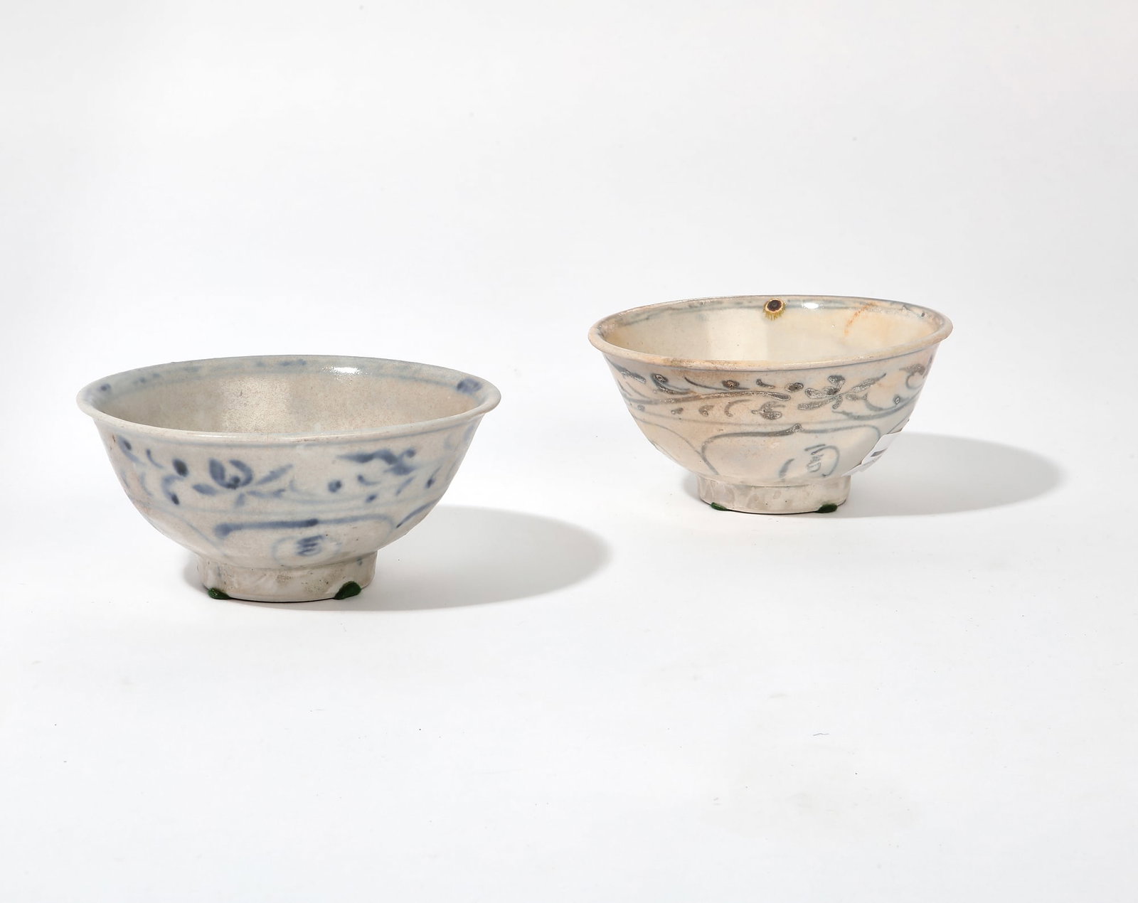 Two Vietnamese bowls: Hoi An Hoard: Two Vietnamese blue and white glazed bowls: Hoi An Hoard One with SAGA HOI AN HOARD VISAL label to underside. height 2 1/2in (6cm); diameter 5 1/2in (14cm)