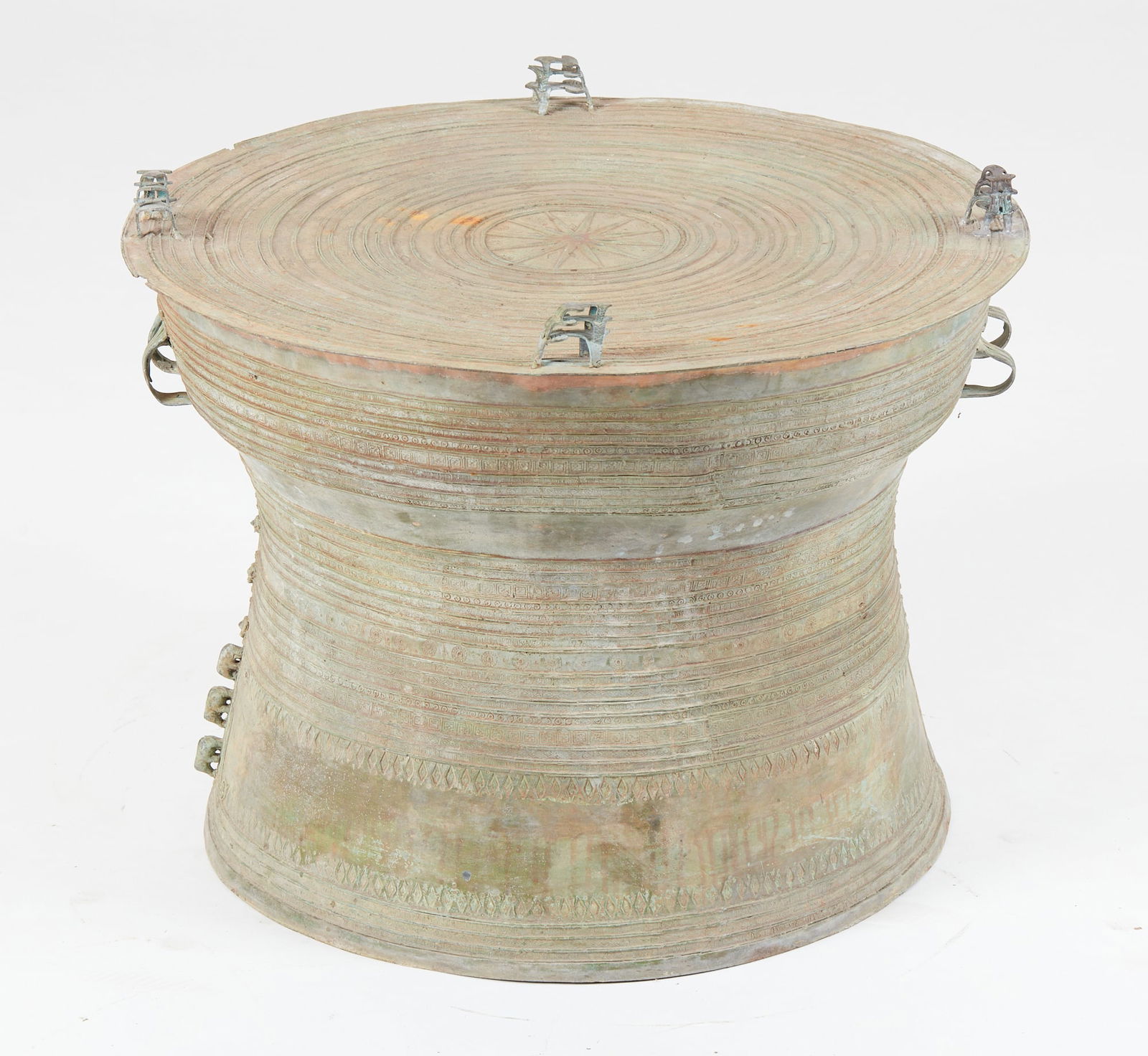 A Southeast Asian verdigris bronze rain drum: A Southeast Asian verdigris bronze rain drumheight 19in (48cm); diameter 24in (61cm)