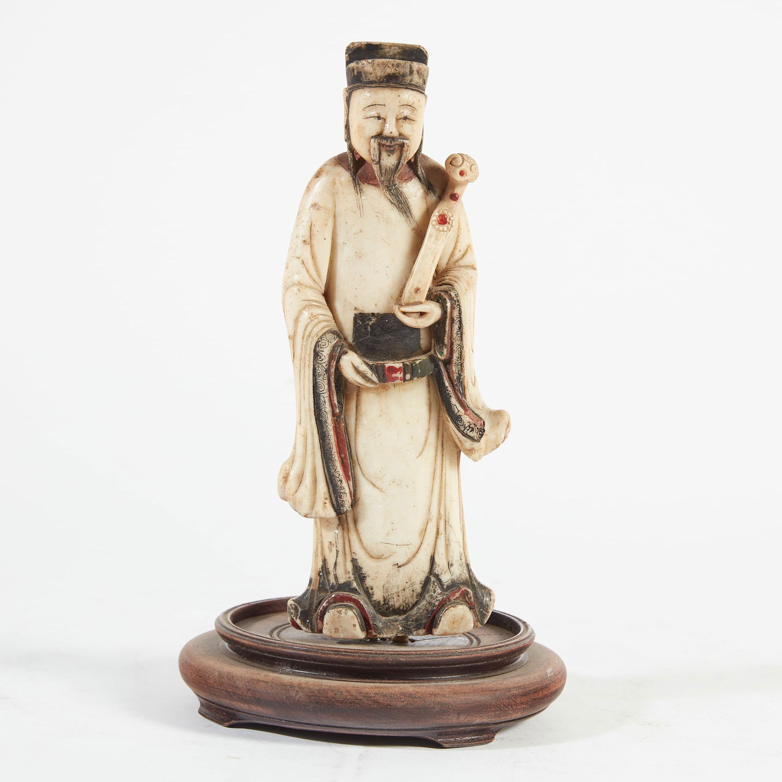 A Chinese soapstone model of a court official: A Chinese soapstone model of a court officialOn wooden stand.height 11 3/4in (29.5cm)
