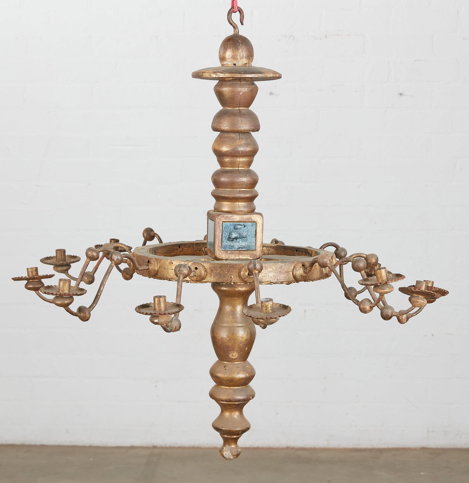 An Italian Baroque style twelve light chandelier: An Italian Baroque style mirrored glass inset giltwood and gilt metal twelve light chandelier 19th century height 37 1/2in (95cm); diameter 35 1/2in (90cm)