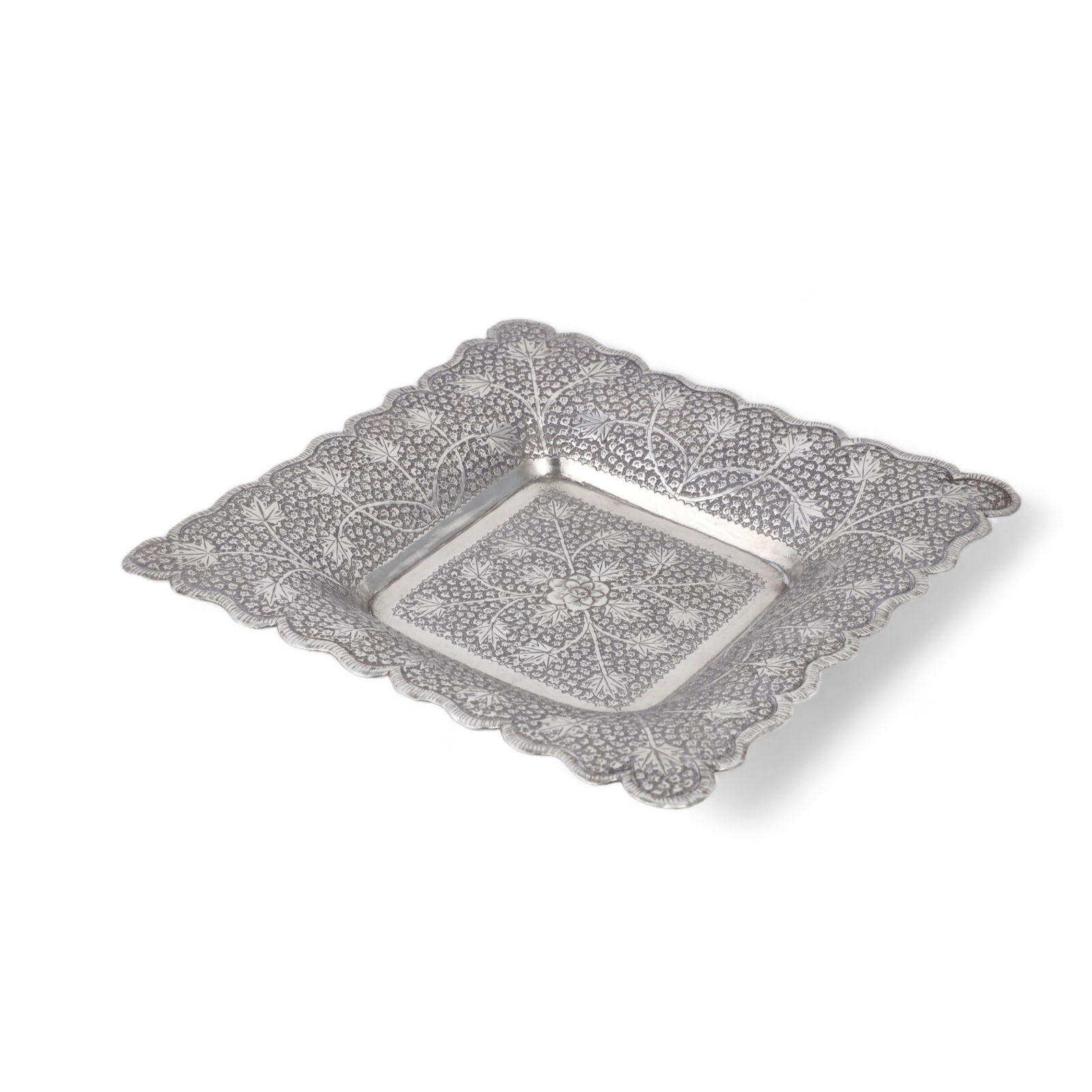 An Indian repousse decorated silver square dish (1 of 4)