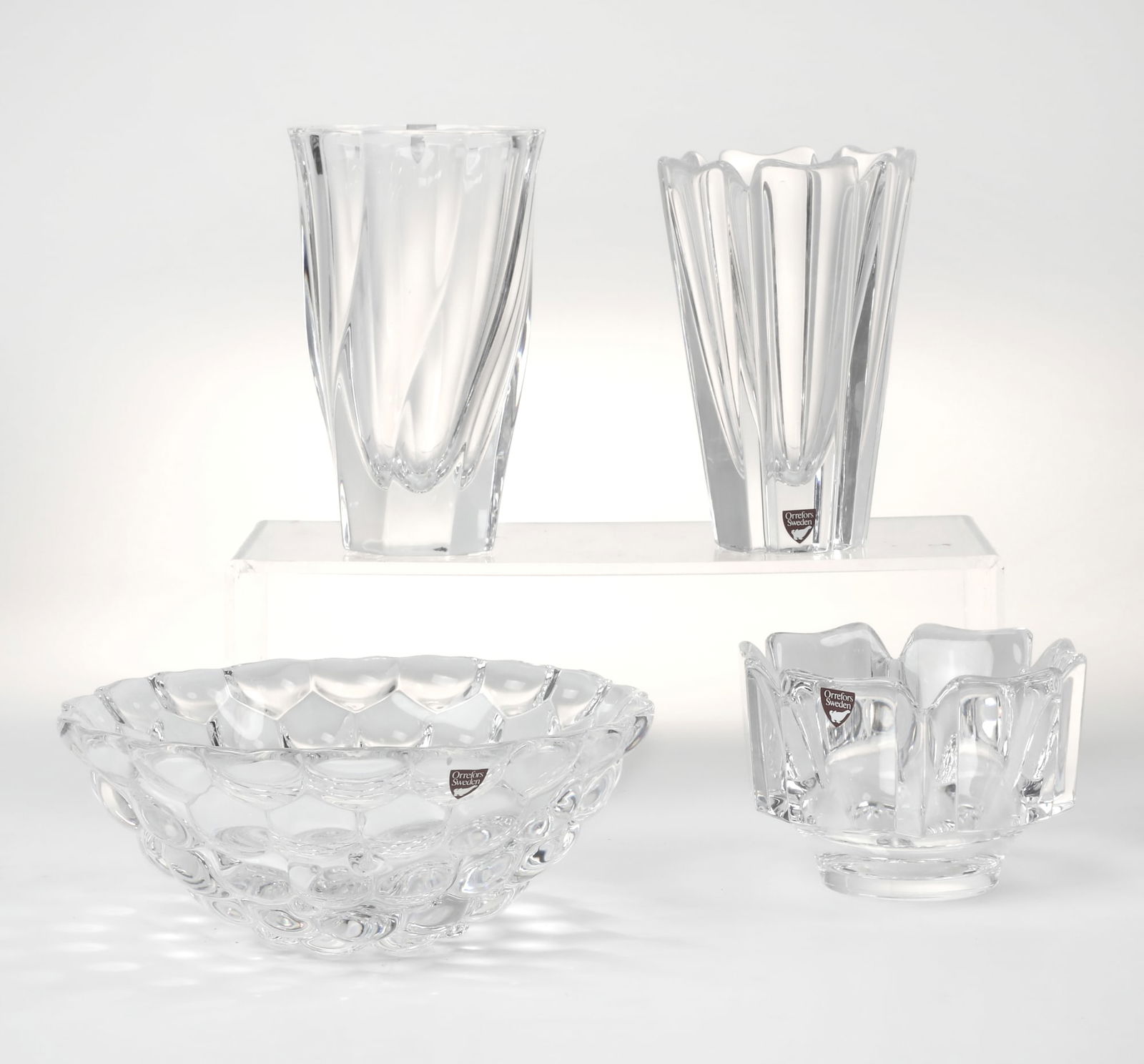 A group of four Orrefors clear glass articles: A group of four Orrefors clear glass articlesmodernComprising a Corona vase and bowl, designed by Lars Hellsten; Hallon Raspberry bowl, designed by Anne Nilsson and Residence vase, designed by Olle Al