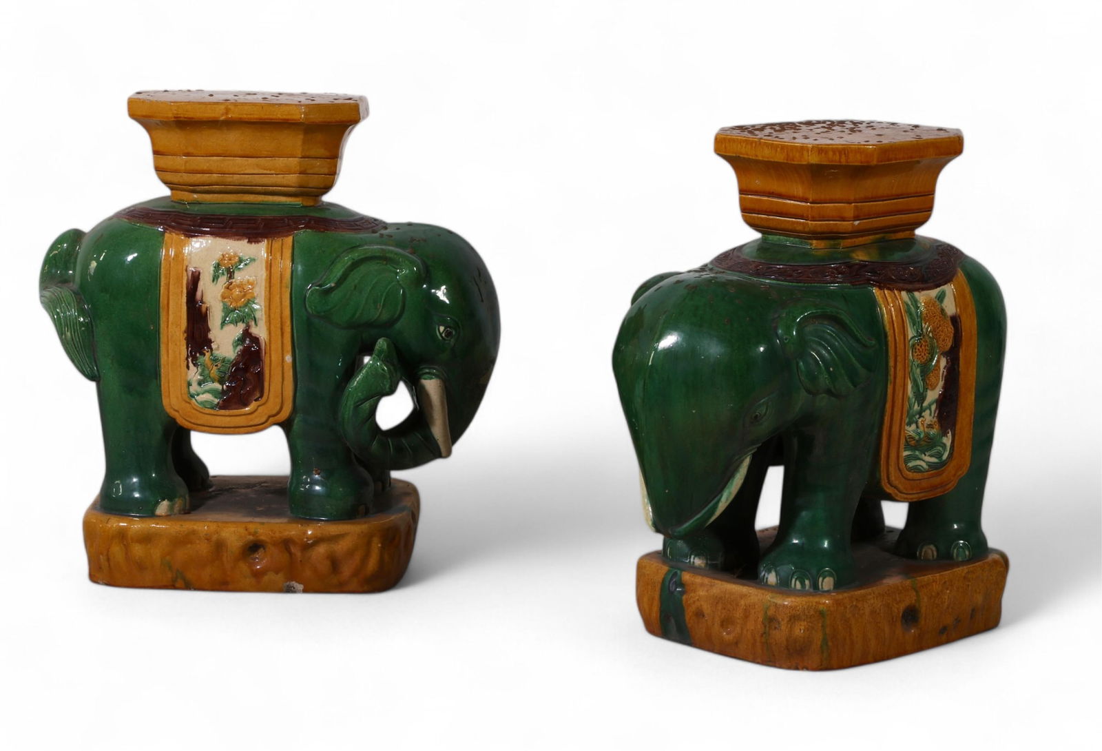 A pair of Chinese porcelain elephant garden seats: A pair of Chinese sancai glazed porcelain elephant garden seatsheight 22 1/4in (55.5cm); width 18 1/2in (46cm); depth 11 1/2in (29cm)