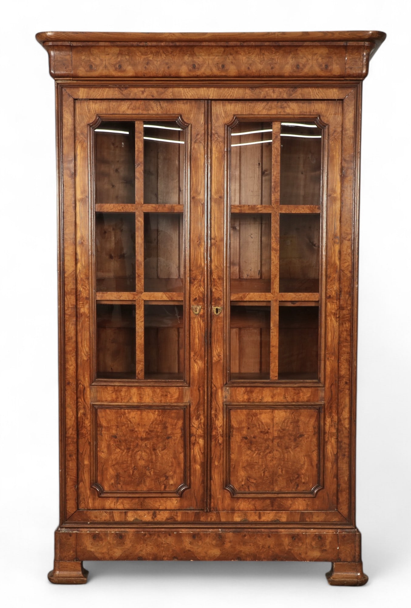 A Louis Philippe elm bibliotheque: A Louis Philippe elm bibliotheque second quarter 19th century height 91in (231cm); width 55in (140cm); depth 24in (61cm)