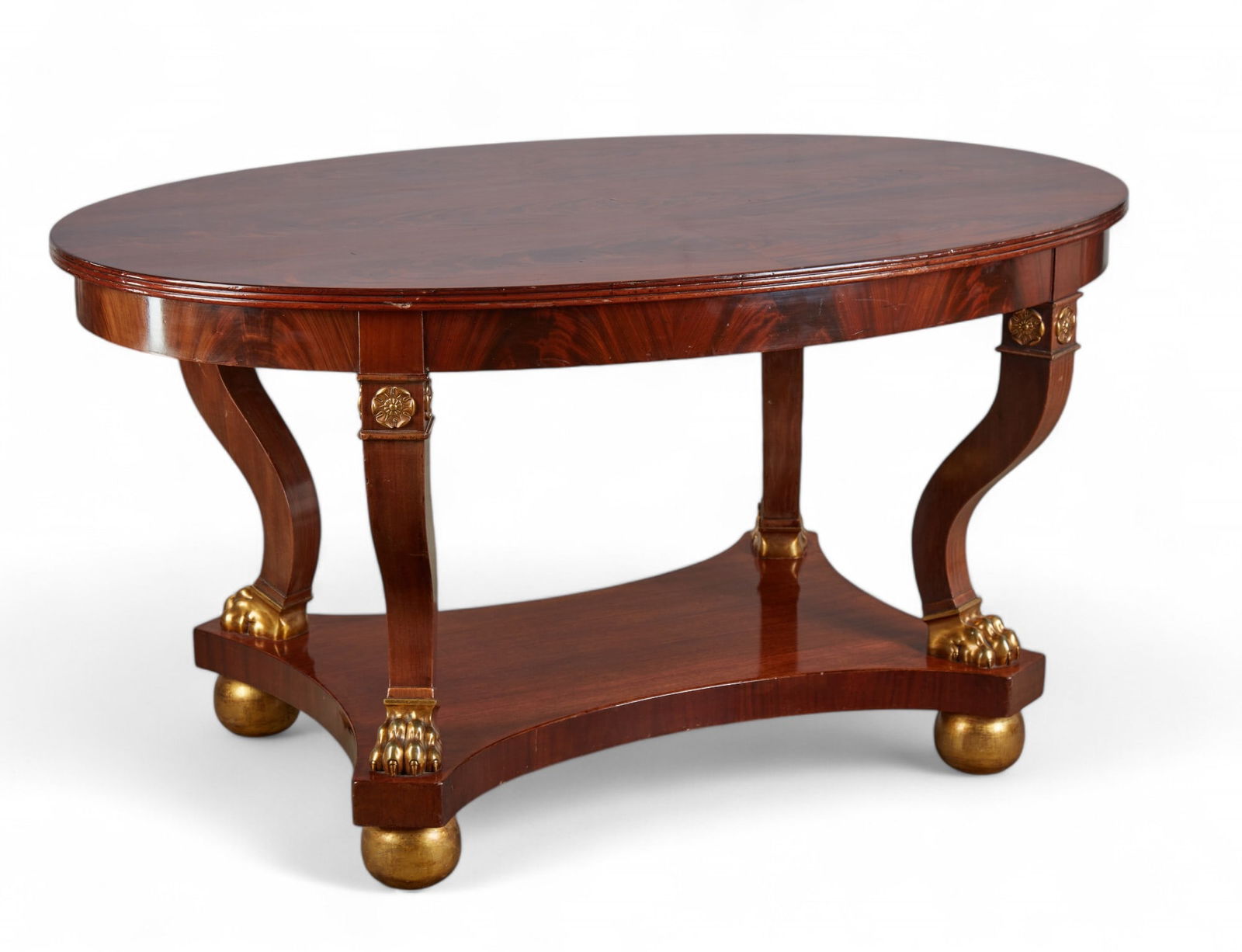 A Swedish Karl-Johan center table: A Swedish Karl-Johan mahogany and parcel gilt center table19th centuryheight 31 1/2in (80cm); width 60 1/4 (153cm); depth 40 1/4in (102cm)