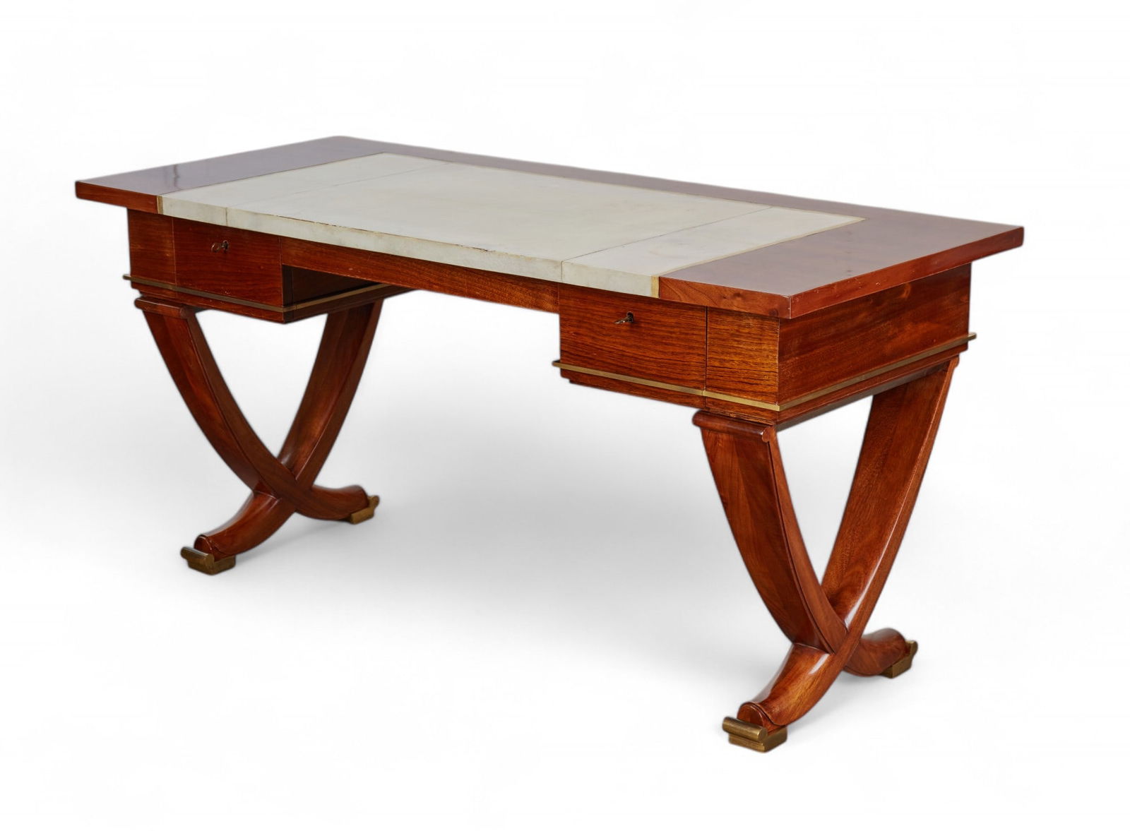 An Andre Arbus brass mounted mahogany desk: An Andre Arbus brass mounted parchment sheathed mahogany desksecond quarter 20th centuryheight 29 1/2in (75cm); width 61in (155cm); depth 26in (66cm) Provenance:With Galerie Jean-Louis Danant, Paris.