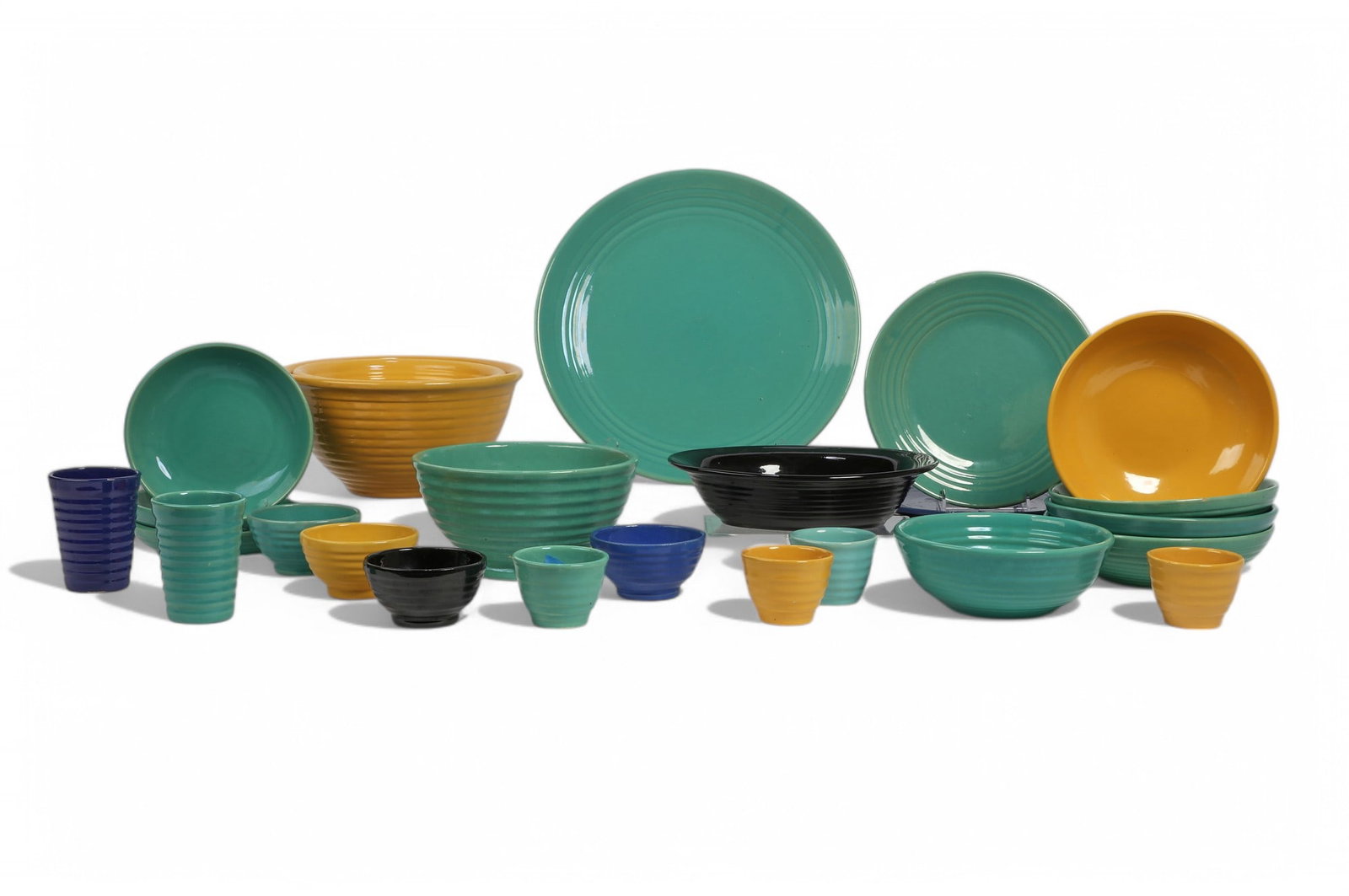 27 piece group of Bauer pottery tableware: An assembled twenty seven piece collection of Bauer pottery tableware20th centuryComprising nineteen bowls, four dinner plates, two tumblers, a round platter, and an oval serving bowl.bowl diameters r