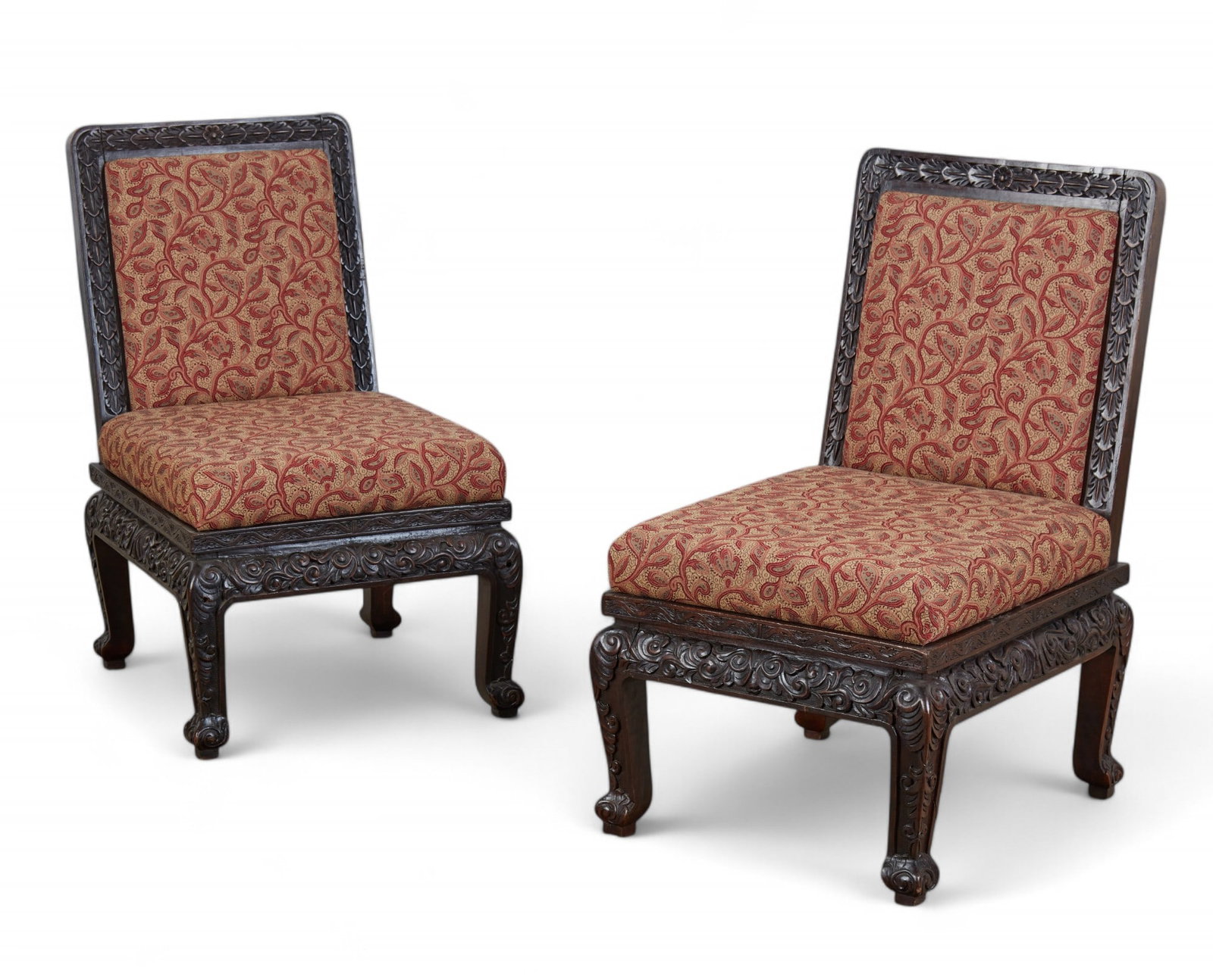 A pair of Asian hardwood slipper chairs: A pair of Asian hardwood slipper chairs height 35in (89cm); width 21in (54cm); depth of seat 20in (51cm)