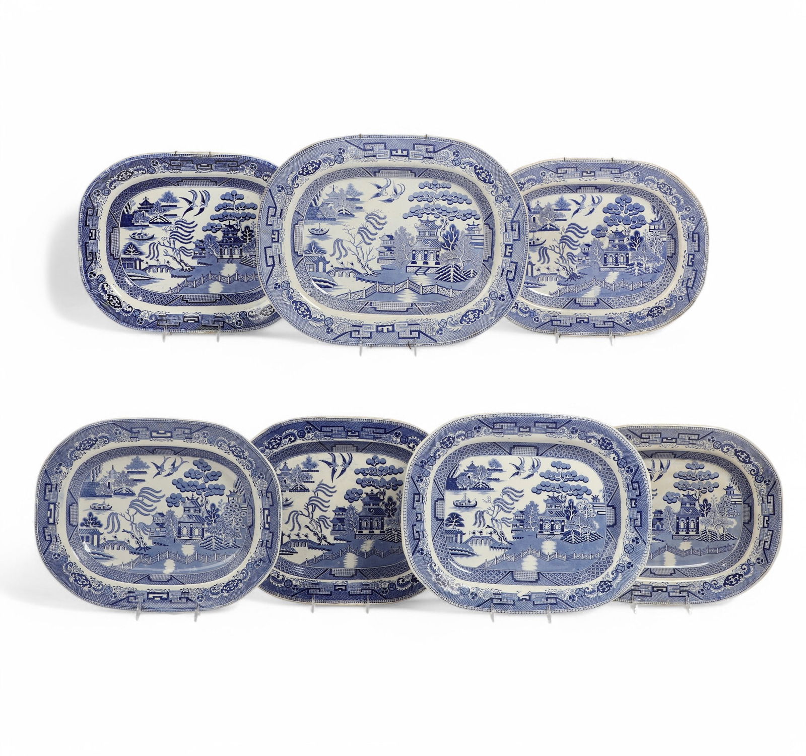Seven English glazed ceramic Blue Willow platters: Seven English glazed ceramic Blue Willow platterslargest length 18in (46cm); width 14 1/4in (36cm)