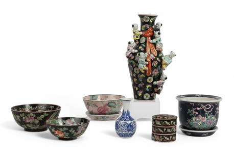 Seven Chinese glazed porcelain table decorations: A group of seven Chinese polychrome glazed porcelain table decorationsComprising a Famille Noire fertility vase, two bowls, and a three tiered box, a blue ground jardiniere, a rose ground floral bowl