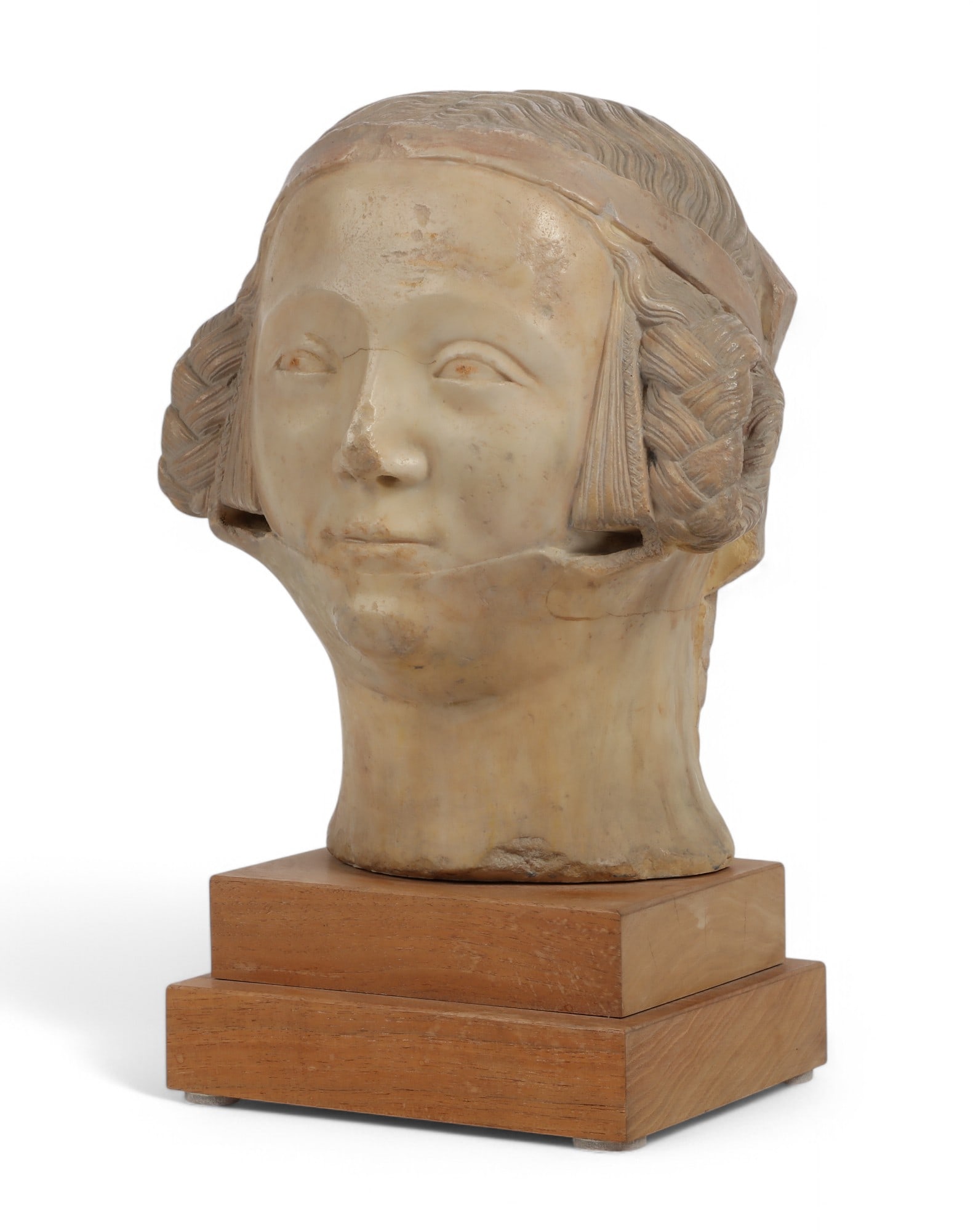 A carved alabaster bust of a woman, Alva Studios: A carved alabaster bust of a womanAlva Studioslast quarter 20th centuryIncised to reverse ? 80 / ALVA and on tiered wood plinth.overall height 14 1/2in (36cm); with 10 1/2in (26cm); depth 6in (15cm)
