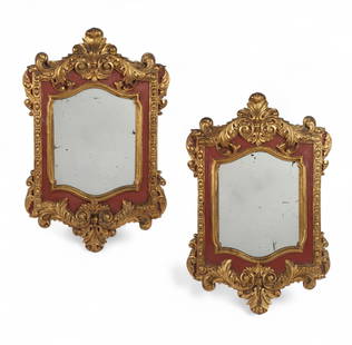 A pair of Italian Baroque style mirrors: A pair of Italian Baroque style parcel gilt and red painted mirrorsmodernheight 28 1/2in (71cm); width 19in (47.5cm); depth 1 3/4in (4.5cm)