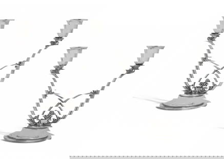 A pair of Danish sterling silver candelabra, designed by Harold Nielson for Georg Jensen: A pair of Danish sterling silver two light Acorn candelabra designed by Harold Nielson for Georg Jensen Silversmithy, Copenhagen mid 20th century Model 619. height 6 5/8in (16.8cm); width 6 3/4in
