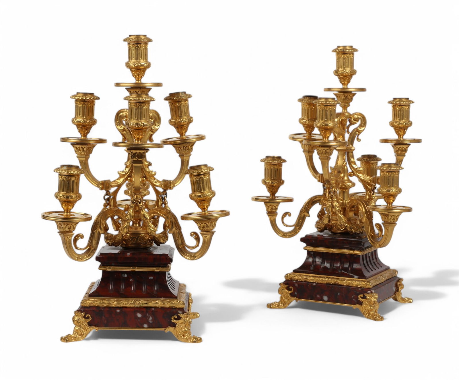 A pair of French gilt bronze and rouge griotte marble seven light candelabra, third quarter 19th c: A pair of French gilt bronze and rouge griotte marble seven light candelabrathird quarter 19th centuryheight 17 1/2in (44.5cm); diameter 11in (28cm) Provenance:Sold A Golden Age: An Important Collecti