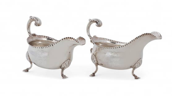 A pair of George III sterling silver sauce boats, William Sampei, London, 1764: A pair of George III sterling silver sauce boatsWilliam Sampei, London1764With coat-of-arms.height 4 1/2in (11cm); width 7in (17.5cm); depth 3 1/2in (9cm); total weight approximately 17oz troy Prov