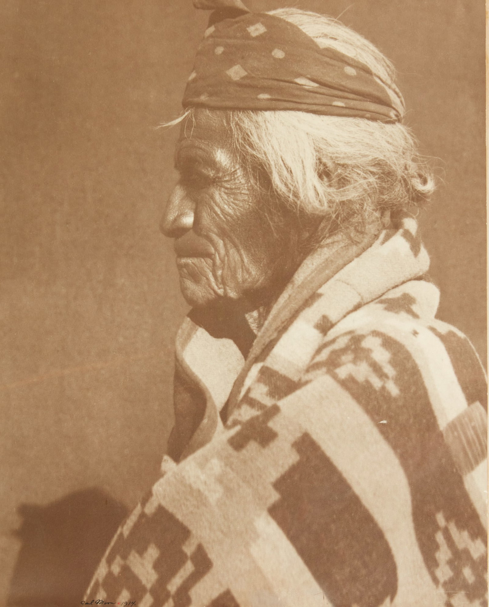 Carl Everton Moon (American, 1878-1948), signed photograph of Navajo Elder Tl izi lani (Many Goats): Carl Everton Moon(American, 1878-1948)Navajo Elder; Tl izi lani (Many Goats)silver gelatin print on papersigned in ink lower left Carl Moon 1914; Fred Harvey printer; with their blindstamp and copyrig