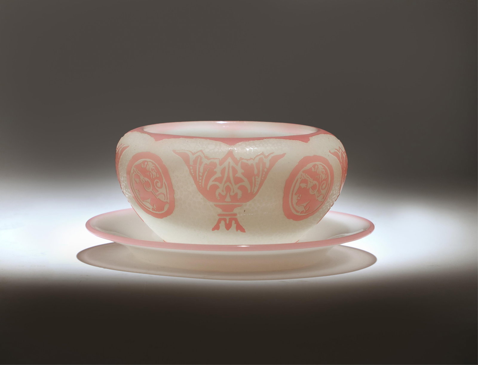 A Steuben Pomona acid-etched glass bowl and underplate, Frederick Carder era, circa 1905-1915: A Steuben Pomona acid-etched glass bowl and underplate, Frederick Carder era, circa 1905-1915The bowl of compressed circular form, with pink overlay cut to white in stylized urn and roundel motifs, to