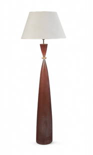 A mid-century modern acrylic floor lamp: A mid-century modern acrylic floor lampOf hourglass form with twin conical sections in amber/orange acrylic, brass collar and fittings, with cream fabric shadeheight 66in (167.5cm)