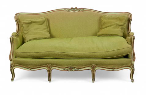 A Louis XV style giltwood canape: A Louis XV style giltwood canapeWith arched back and floral-carved crest over a serpentine seat rail, raised on cabriole legs. Painted green and gilt, upholstered in textured chartreuse fabric with ma