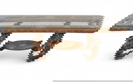 A giltwood and bronze mermaid glass-top coffee table: A giltwood and bronze mermaid glass-top coffee tableThe rectangular beveled glass top set into a molded giltwood frame with scrolling foliate decoration, supported on four patinated bronze mermaid-for