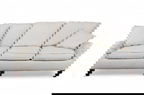 A three-seat sofa with rolled arms and linen-style upholstery: A three-seat sofa with rolled arms and linen-style upholsteryCream textured fabric with contrast welt trim, loose seat and back cushions, rolled arms, and dark tapered wood legs.height 33 in. (83.8 cm