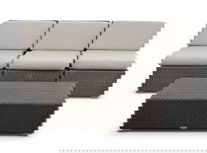 A four-piece Dedon outdoor lounge set, contemporary: A four-piece Dedon outdoor lounge set, contemporaryComprising three armless lounge chairs and a rectangular coffee table, each with woven synthetic fiber frames in espresso tone, the chairs with fitte