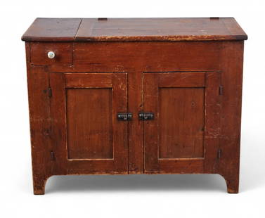 A rustic American pine dry sink cabinet: A rustic American pine dry sink cabinetWith a hinged lift-top compartment, single drawer with ceramic knob, and two paneled doors below. Finished in warm stain with painted interior.height 33in (84cm)