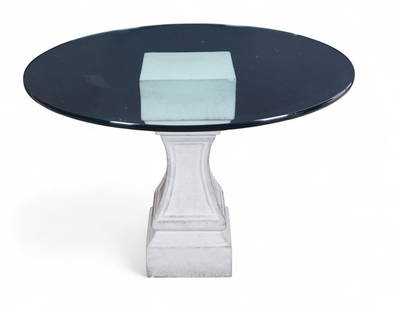 A cast stone table base with round glass top: A cast stone table base with round glass topTable base: height 28 x width 12 x length 12 in. (71.1 x 30.5 x 30.5 cm.), Glass top: diameter 43 in. (109.2 cm.)
