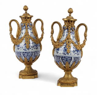 A pair of Louis XVI style gilt bronze mounted blue and white porcelain vases, 20th century: A pair of Louis XVI style gilt bronze mounted blue and white porcelain vases20th centuryheight 19in (48cm); width 8 1/2in (21.5cm); depth 6 1/2in (16cm)
