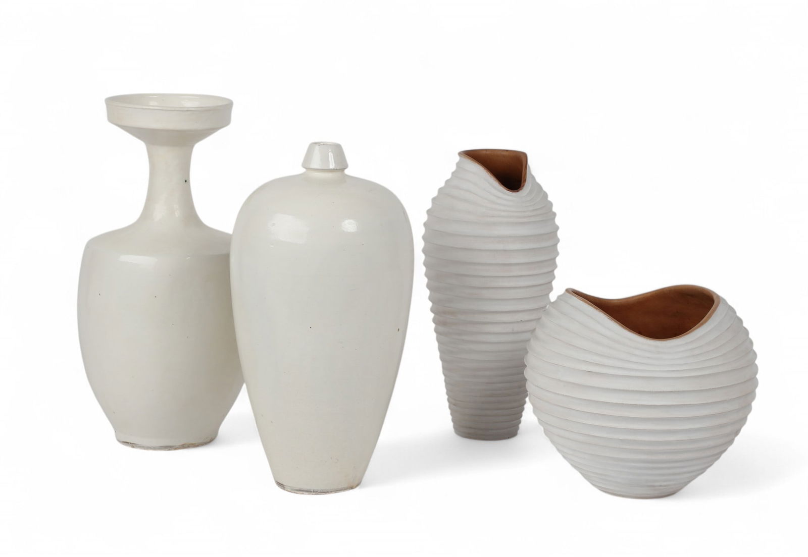A group of four white painted vases: A group of four white painted vases Tallest: height 18 x diameter 8 1/2 in. (45.7 x 21.6 cm.)