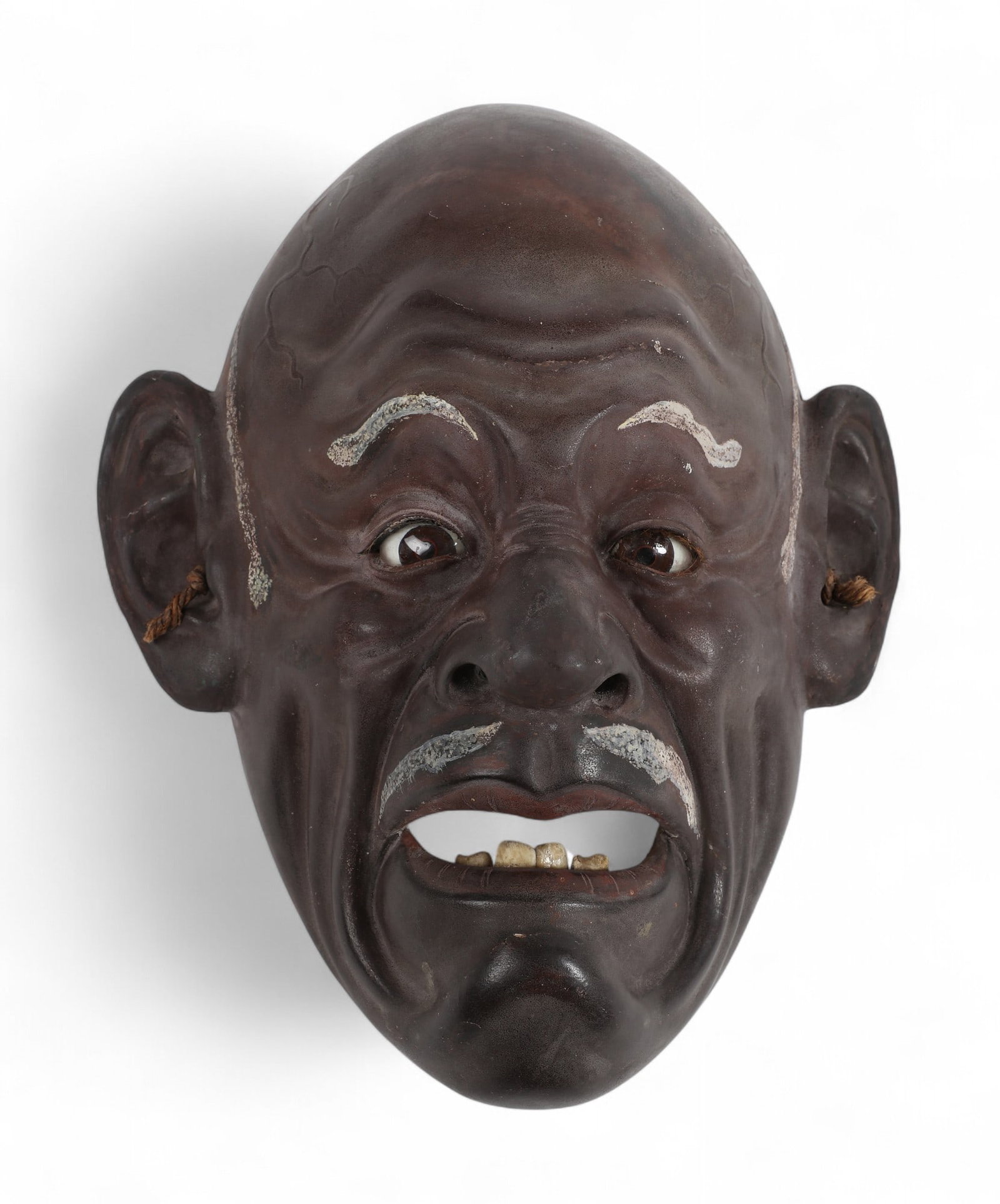 A Japanese mask with glass eyes: A Japanese mask with glass eyes width 8 x length 10 in. ( x 20.3 x 25.4 cm.)