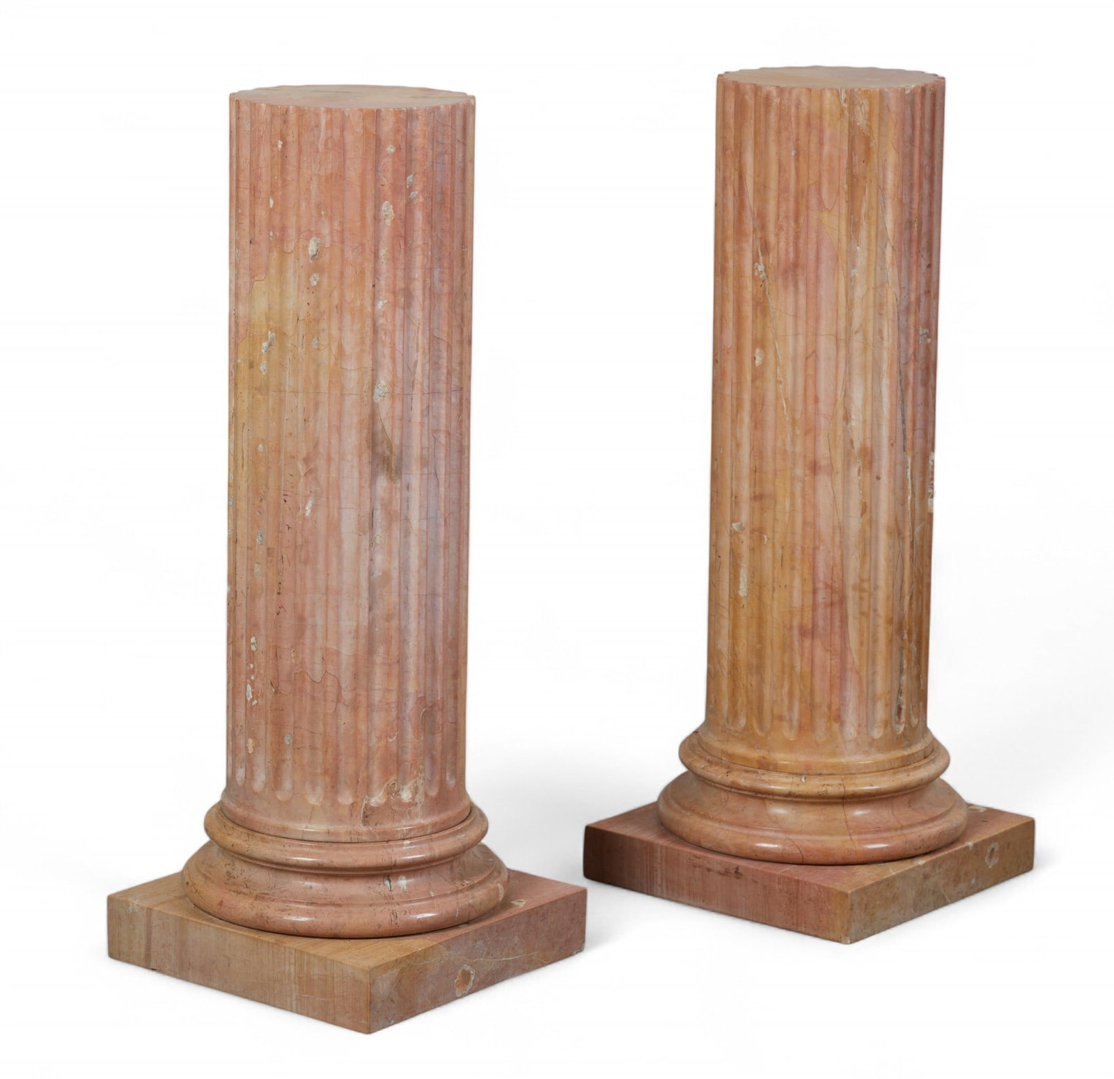 A pair of fluted pink and yellow marble columns, 20th century: A pair of fluted pink and yellow marble columns20th centuryheight 41in (102.5cm); width 16in (40cm) square Provenance:Property from the Private Collection of Larry Bond, Utah.