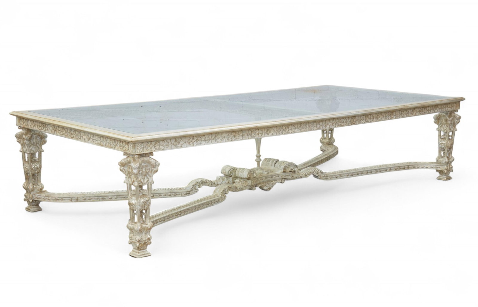 A large Phyllis Morris silver leaf hand carved dining table with glass insert: A large Phyllis Morris silver leaf hand carved dining table with glass insertheight 30 x width 65 1/2 x depth 138 in. (76.2 x 166.4 x 350.5 cm.)