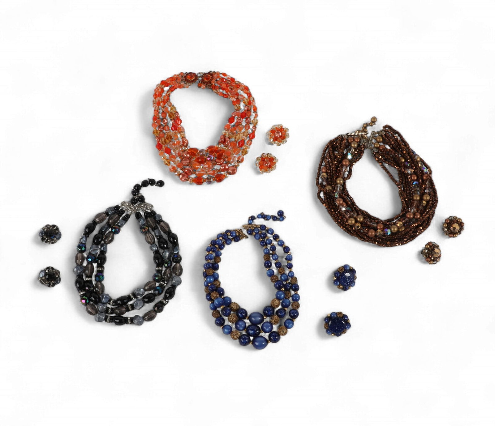 A group of four colorful multi strand necklaces with matching earrings including a set by 'Listner': A group of four colorful multi strand necklaces with matching earrings including a set by 'Listner'