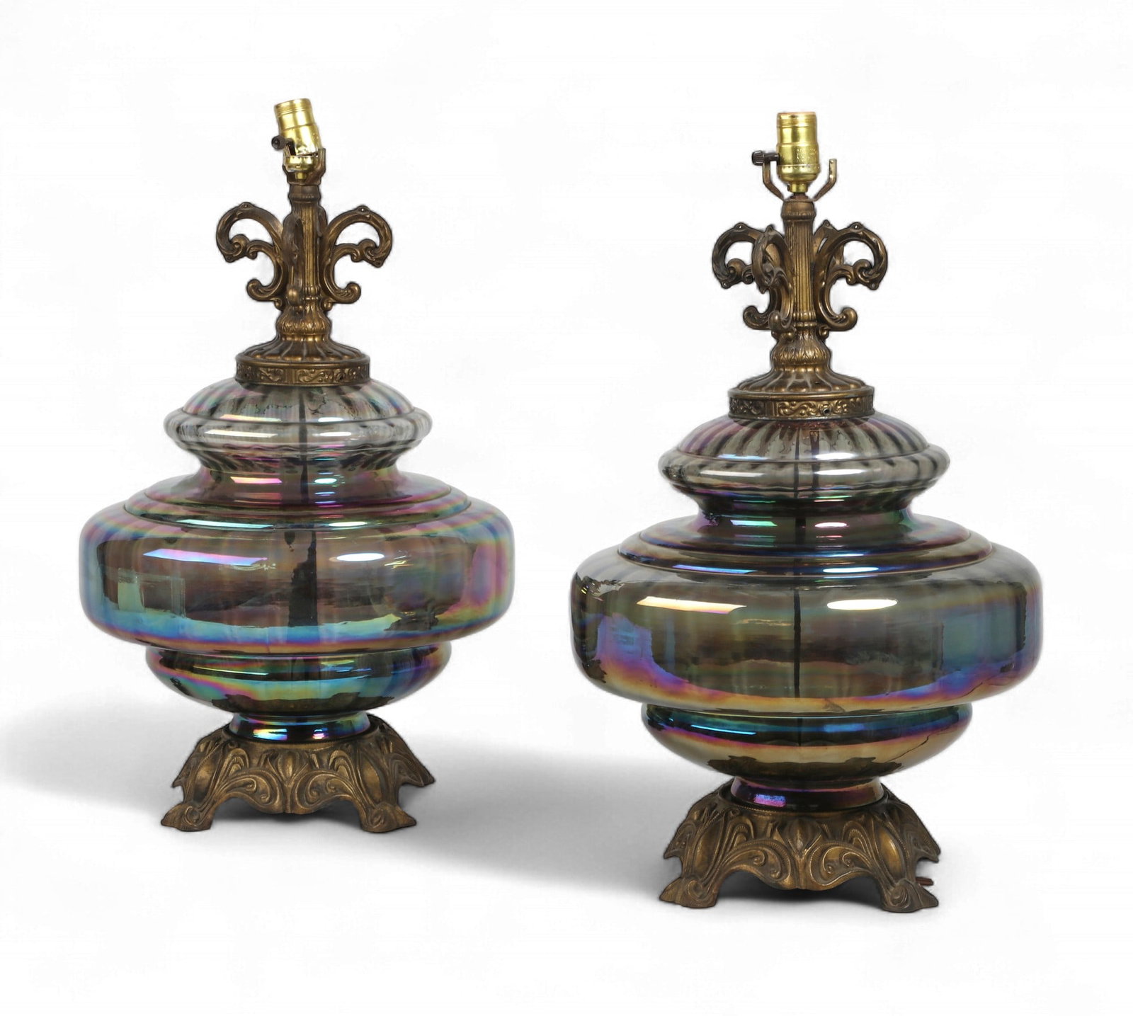 A pair of vintage iridescent carnival glass table lamps: A pair of vintage iridescent carnival glass table lamps height 25 x diameter 14 in. (63.5 x 35.6 cm.)