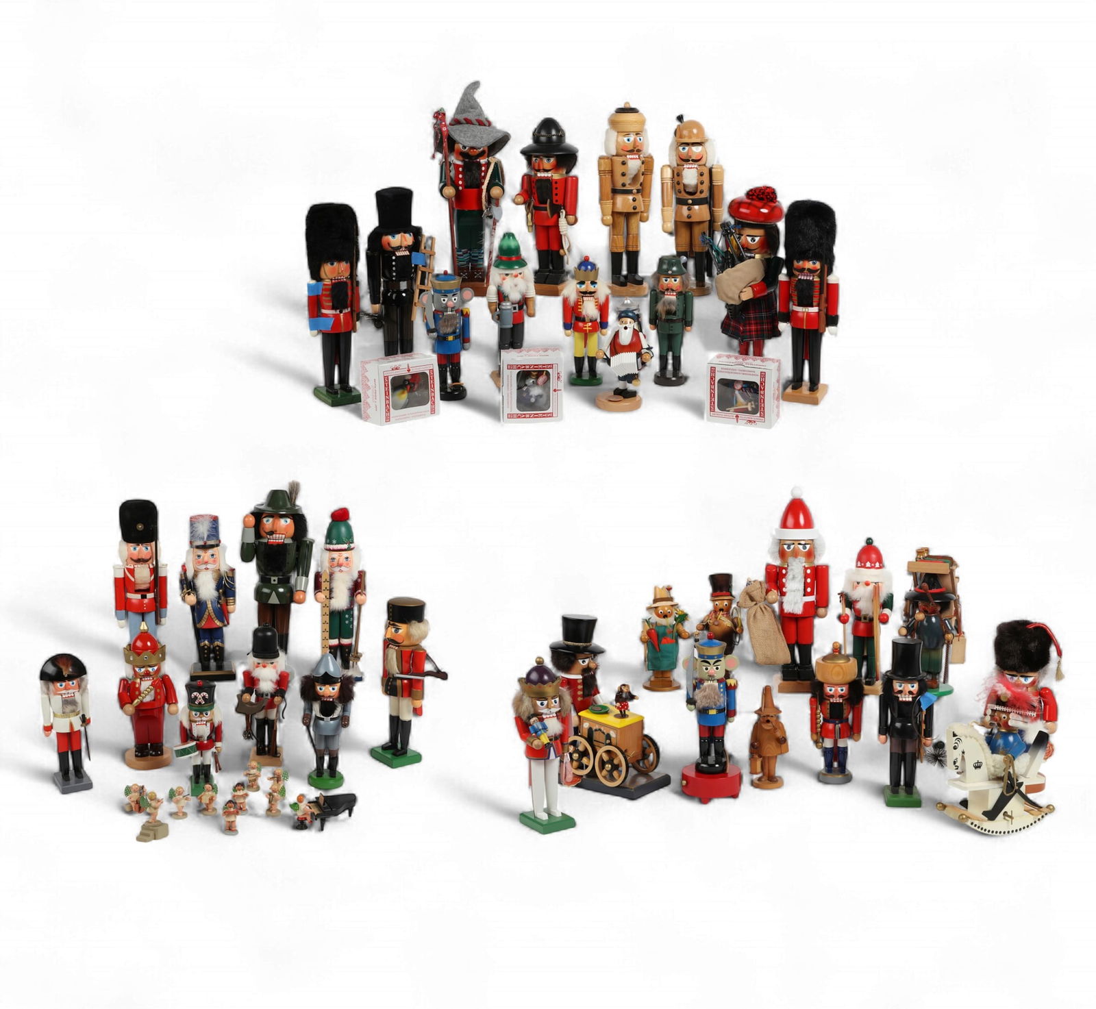 An assembled collection of Christmas nutcrackers, incense burners and decorations, Steinbach,: An assembled collection of Christmas nutcrackers, incense burners and decorations,Steinbach, Erzgebirge, E. M. Merrick, and other makers (58)Comprising six Steinbach nutcrackers - one a music box, thr
