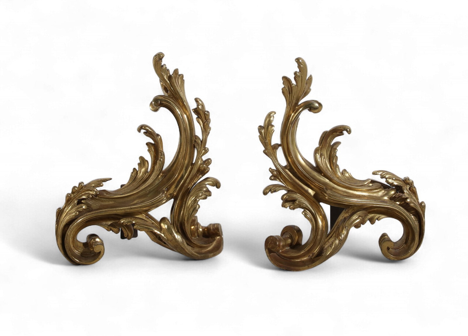 A pair of Louis XV style gilt bronze chenet, late 19th century: A pair of Louis XV style gilt bronze chenet late 19th century height 15 1/2in (39cm); width 12 1/2in (31cm); depth 7 3/4in (18cm) Provenance: Property from the Collection of Larry Bond, Utah.