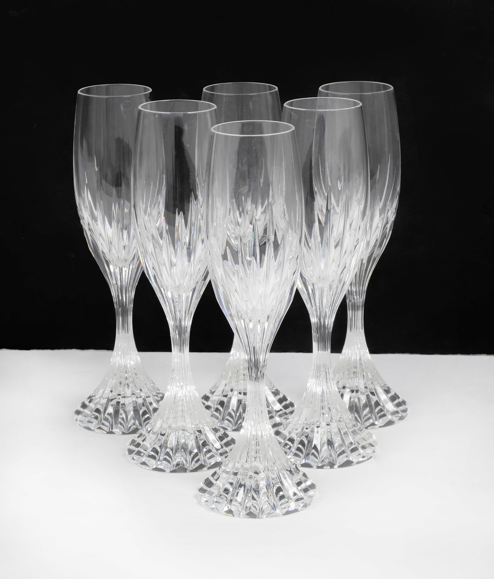 A set of six Baccarat Massena champagne flutes: A set of six Baccarat Massena champagne flutes Each with etched factory mark to underside. height 8 1/2in (21cm) Provenance: Property from the Collection of Lorna and Milton Berle, Beverly Hills, Cali