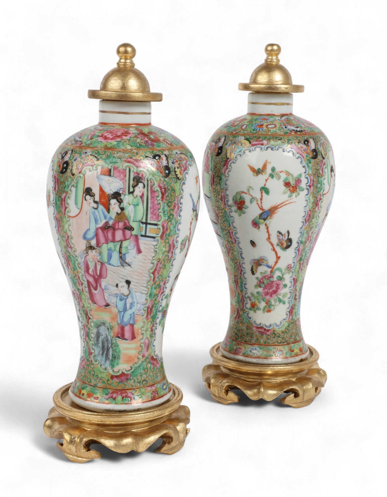 A pair of Chinese Export Famille Rose Medallion vases: A pair of Chinese Export Famille Rose Medallion vasesWith associated giltwood covers and stands.overall height 12 3/4in (31cm); diameter 4 1/2in (11.5cm) Provenance:Property from a Palm Springs Colle