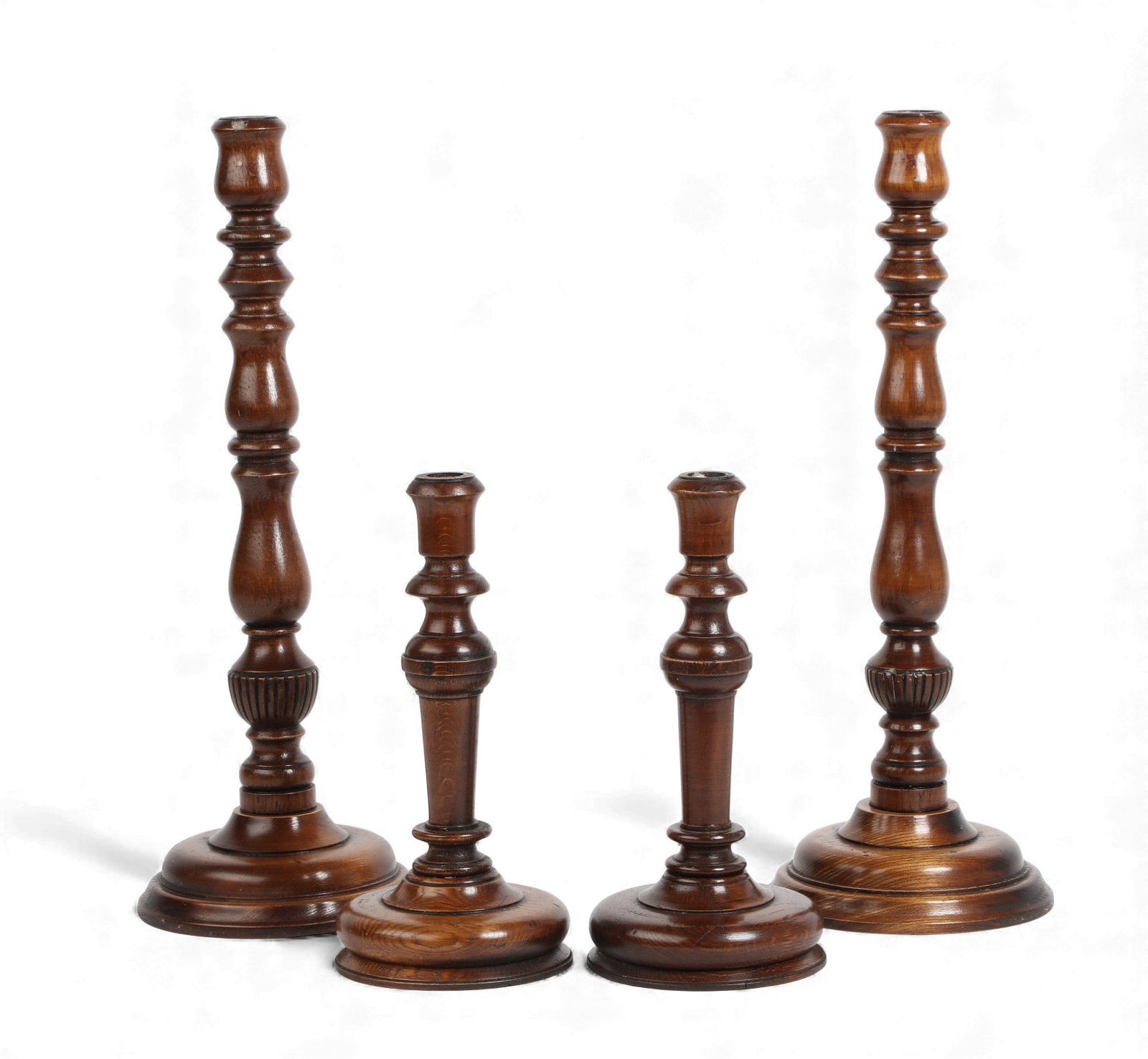 A set of four turned wood candlesticks, modern: A set of four turned wood candlesticksmodernTwo pairs.larger height 21 1/4in (54cm); diameter 7 1/2in (19cm) Provenance:Property from the Collection of Lauren King.