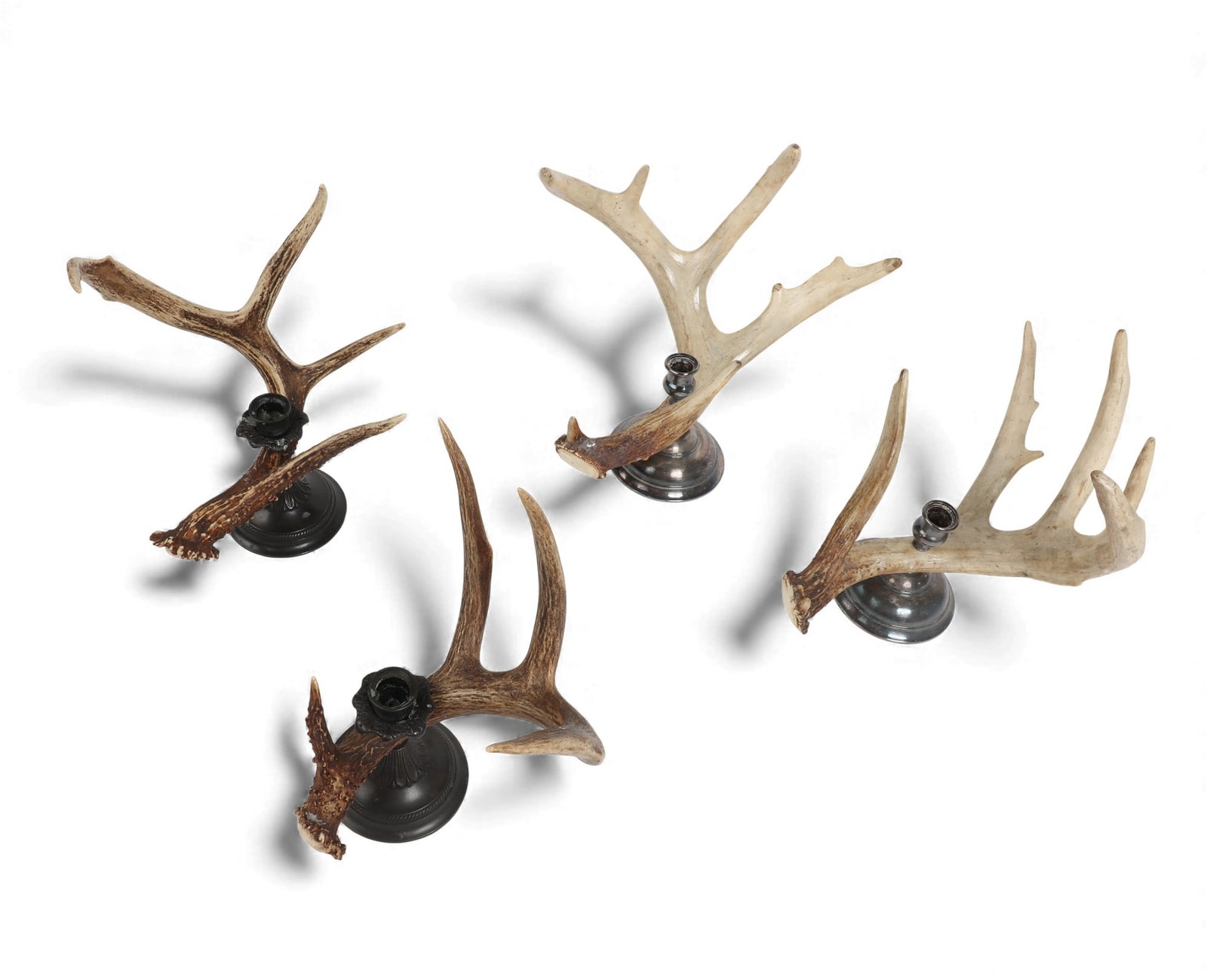 Four metalware mounted antler candlesticks, modern: Four metalware mounted antler candlesticksmodernTwo pairs.larger height 12 1/4in (31cm); width 13 1/2in (34cm); depth 9in (23cm) Provenance:Property from the Collection of Lauren King.