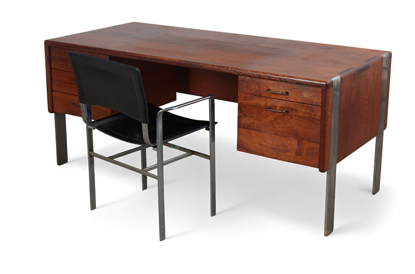 A Gerald McCabe shedua desk and cidue leather arm chair: A Gerald McCabe shedua desk and cidue leather arm chair Desk: height 29 x width 65 x depth 31 in. (73.7 x 165.1 x 78.7 cm.)