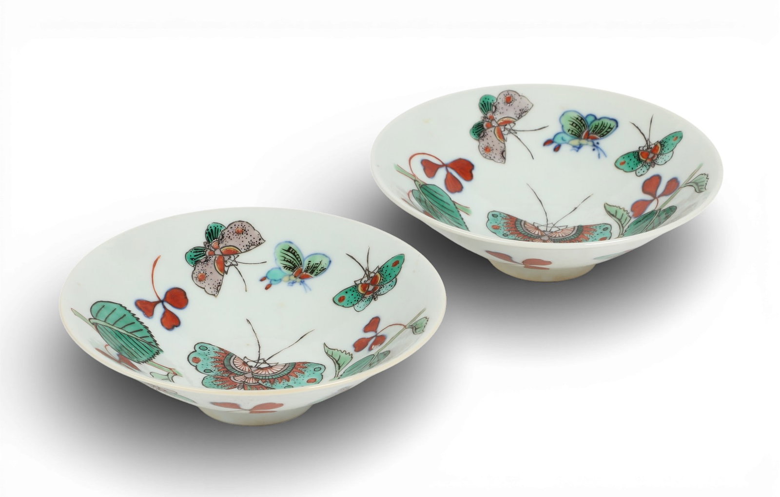 A pair of Chinese Famille Rose porcelain butterfly bowls: A pair of Chinese Famille Rose porcelain butterfly bowls Each with six character mark within blue double circle mark to underside. height 1 1/2in (4cm); diameter 5 1/4in (13cm) Provenance: Property fr