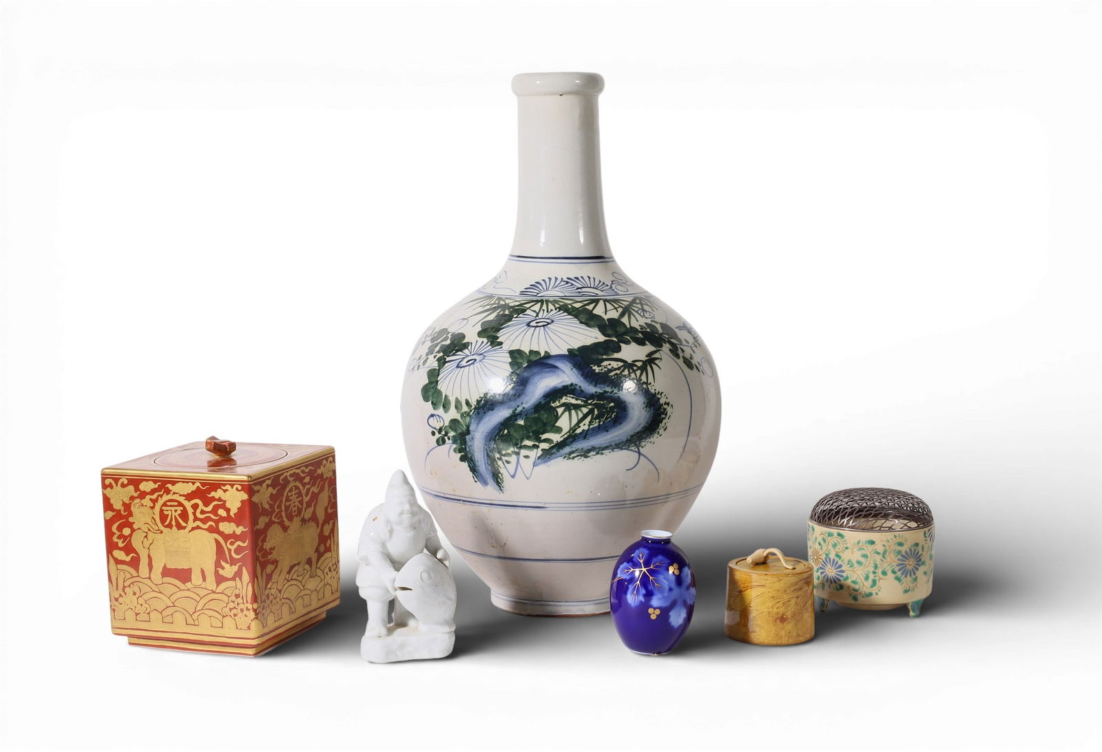 A six piece group of Asian ceramic wares, mostly Japanese: A six piece group of Asian ceramic waresmostly JapaneseComprising a bottle vase, a rust glazed square jar, a Satsuma censer, a mottled mustard glazed cylindrical jar mared to underside, a white glazed