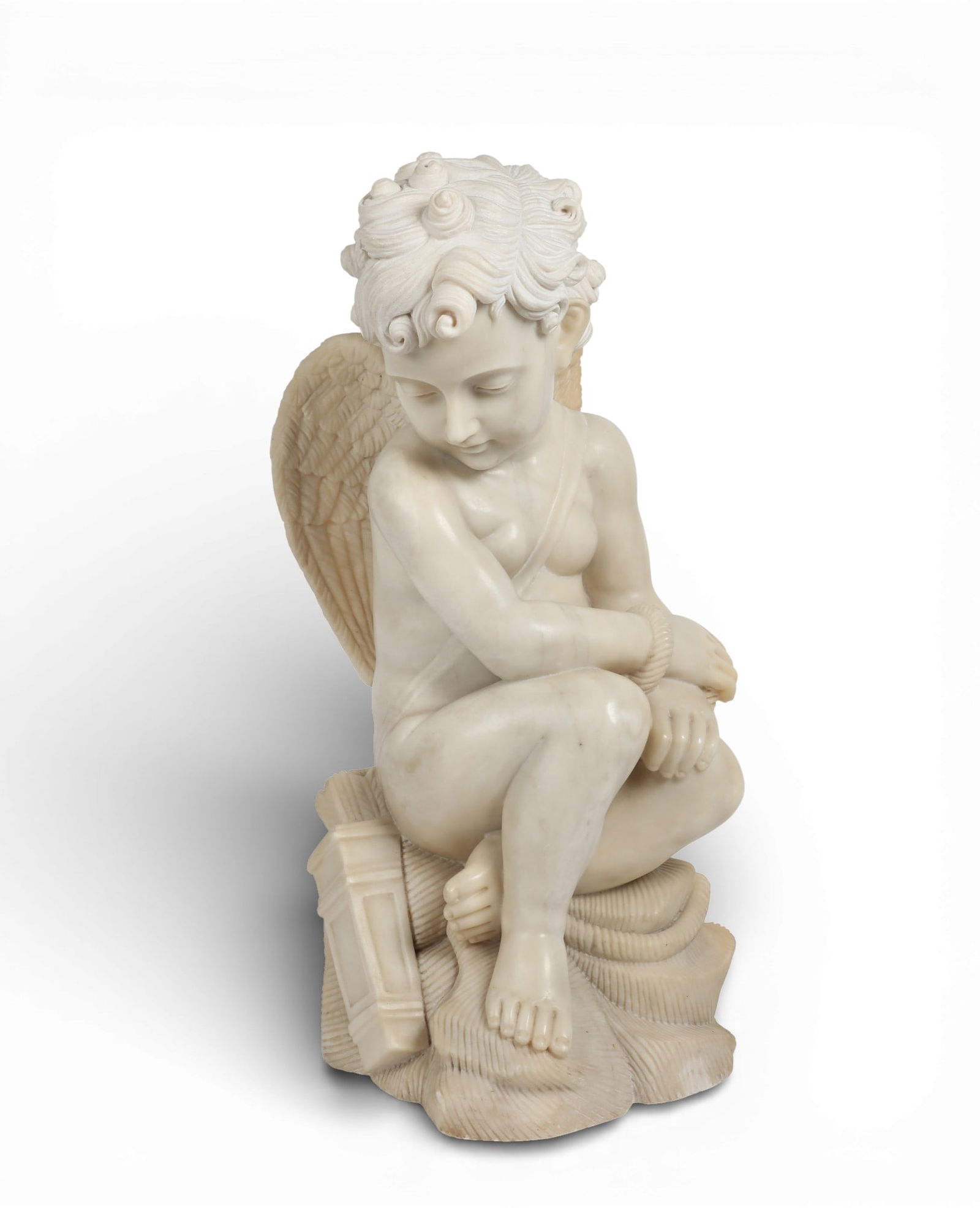 A Continental carved white marble figure of cupid bound, 20th century: A Continental carved white marble figure of cupid bound20th centuryheight 24in (61cm); width 11in 28cm); depth 14in (35.5cm) Provenance:Property from a Private Collection, San Francisco, California.