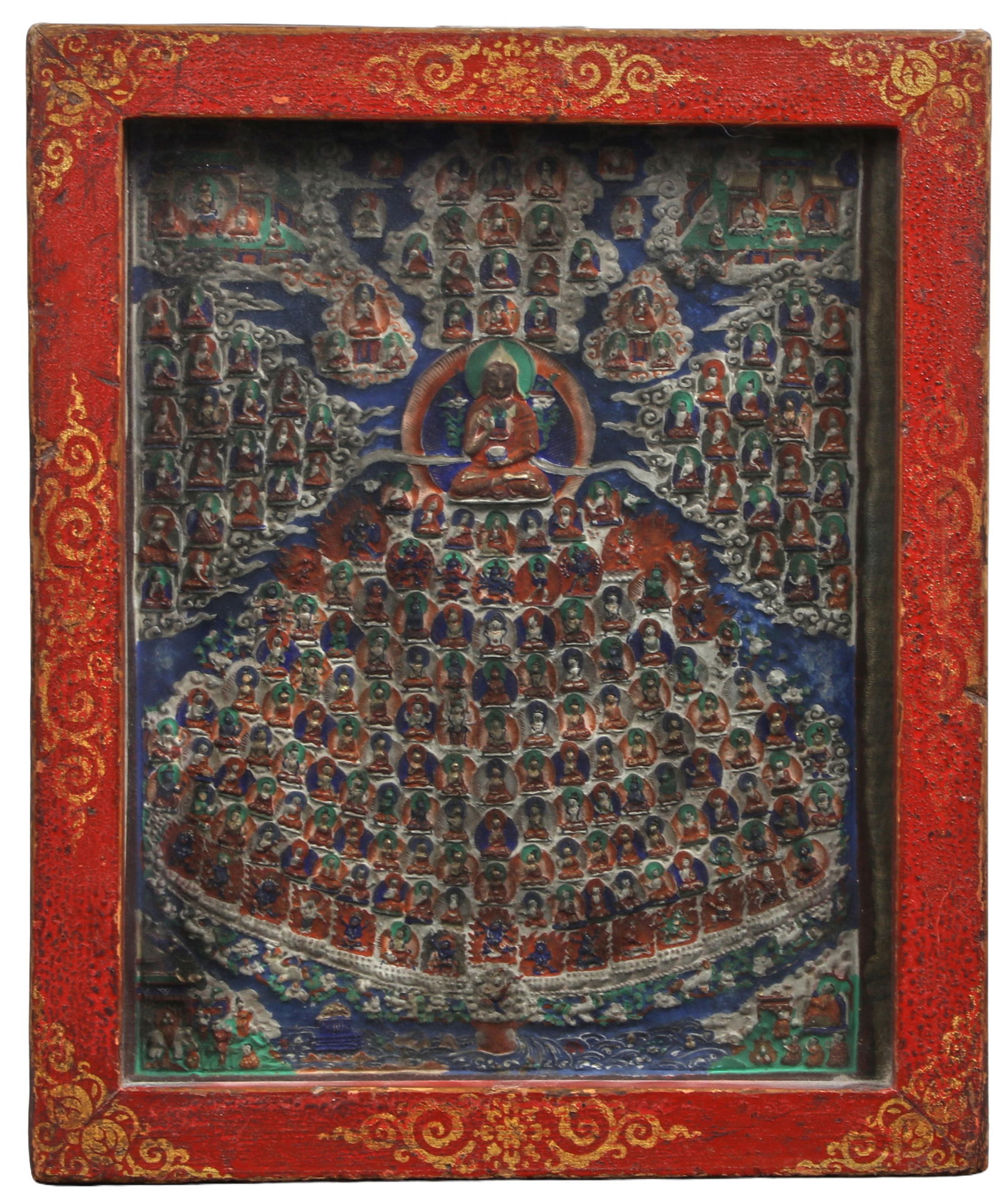 A Tibetan Buddhist painted ceramic thangka depicting a Refuge Tree: A Tibetan Buddhist painted ceramic thangka depicting a Refuge TreeFramed under glass in a red and parcel gilt painted wood frame.height 12 1/2in (31cm); width 10 1/2in (26cm); depth 2in (5cm) Provenan