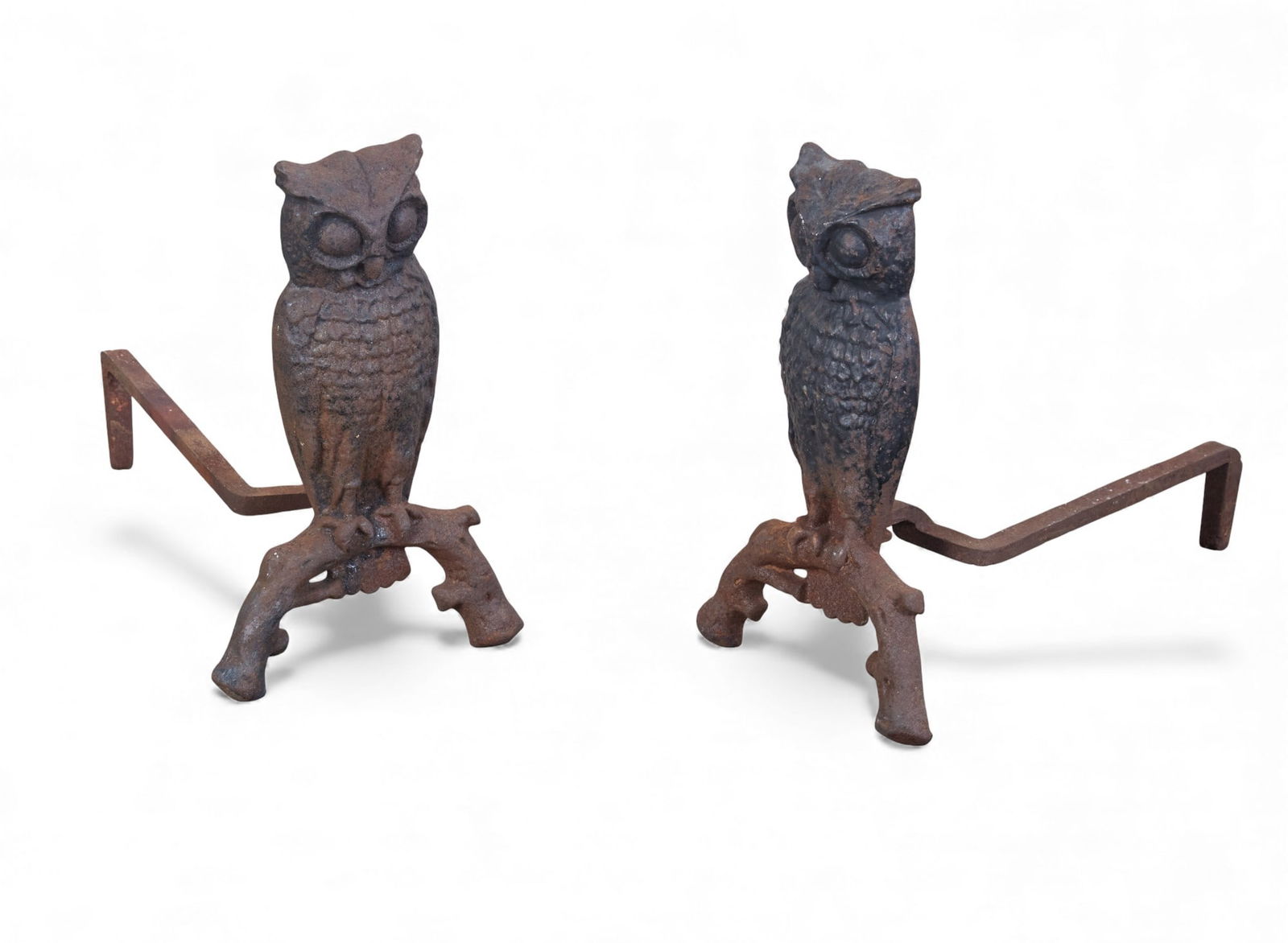 A pair of cast iron owl form andirons, 20th century: A pair of cast iron owl form andirons20th centuryheight 13 3/4in (34.5cm); width 8 1/2in (21cm); depth 15in (37.5cm)