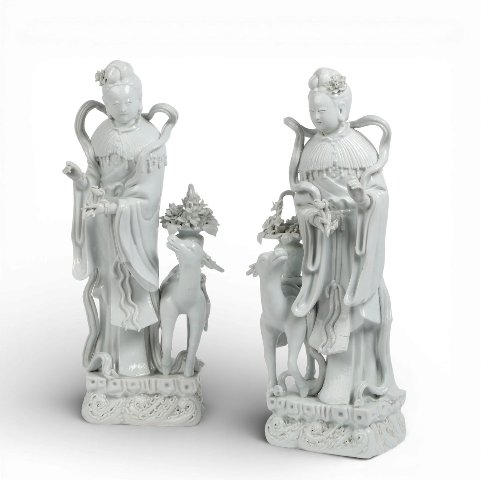 A pair of Chinese dehua porcelain figures of Guanyin with a deer: A pair of Chinese dehua porcelain figures of Guanyin with a deerlargest height 18 1/2in (46cm); width 8in (20cm); depth 7in (17.5cm) Provenance:Property from a Private Collection, San Francisco, Calif